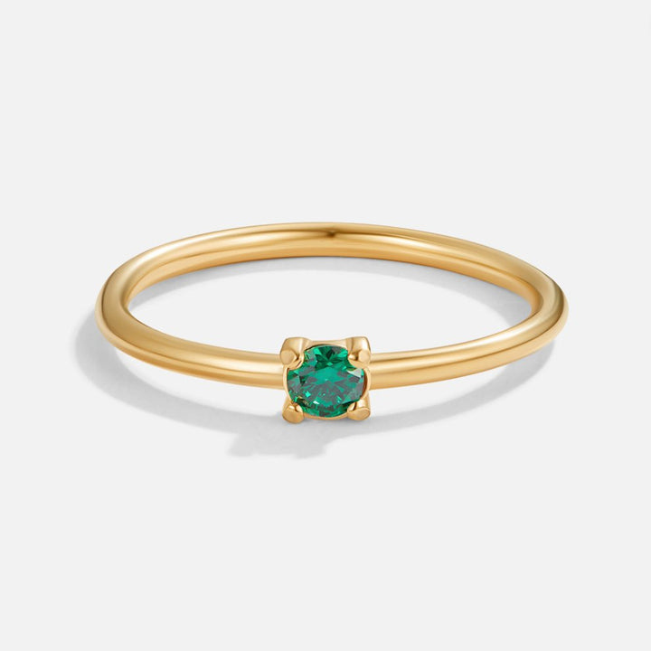 Bague en or avec pierre de naissance" → "Bague ornée de pierre de naissance