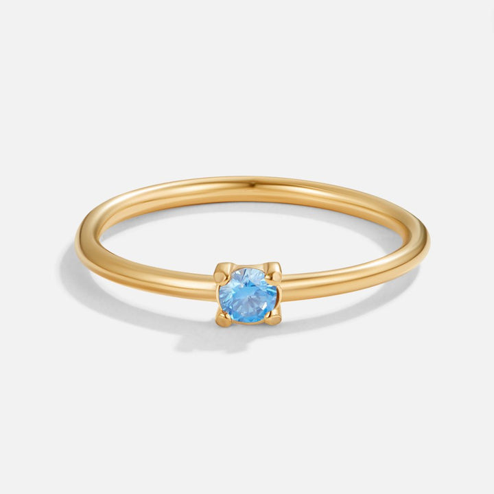 Bague en or avec pierre de naissance" → "Bague ornée de pierre de naissance